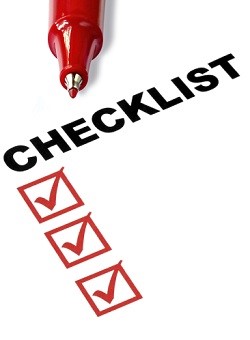 Checklist with red felt pen, and checked boxes.